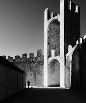 Dramatic black and white photo of a person in an ancient fortress.
