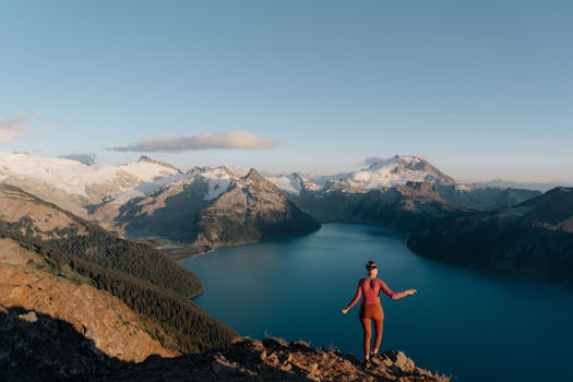 Woman enjoying sunset view over Garibaldi Lake, Whistler, BC, Canada.