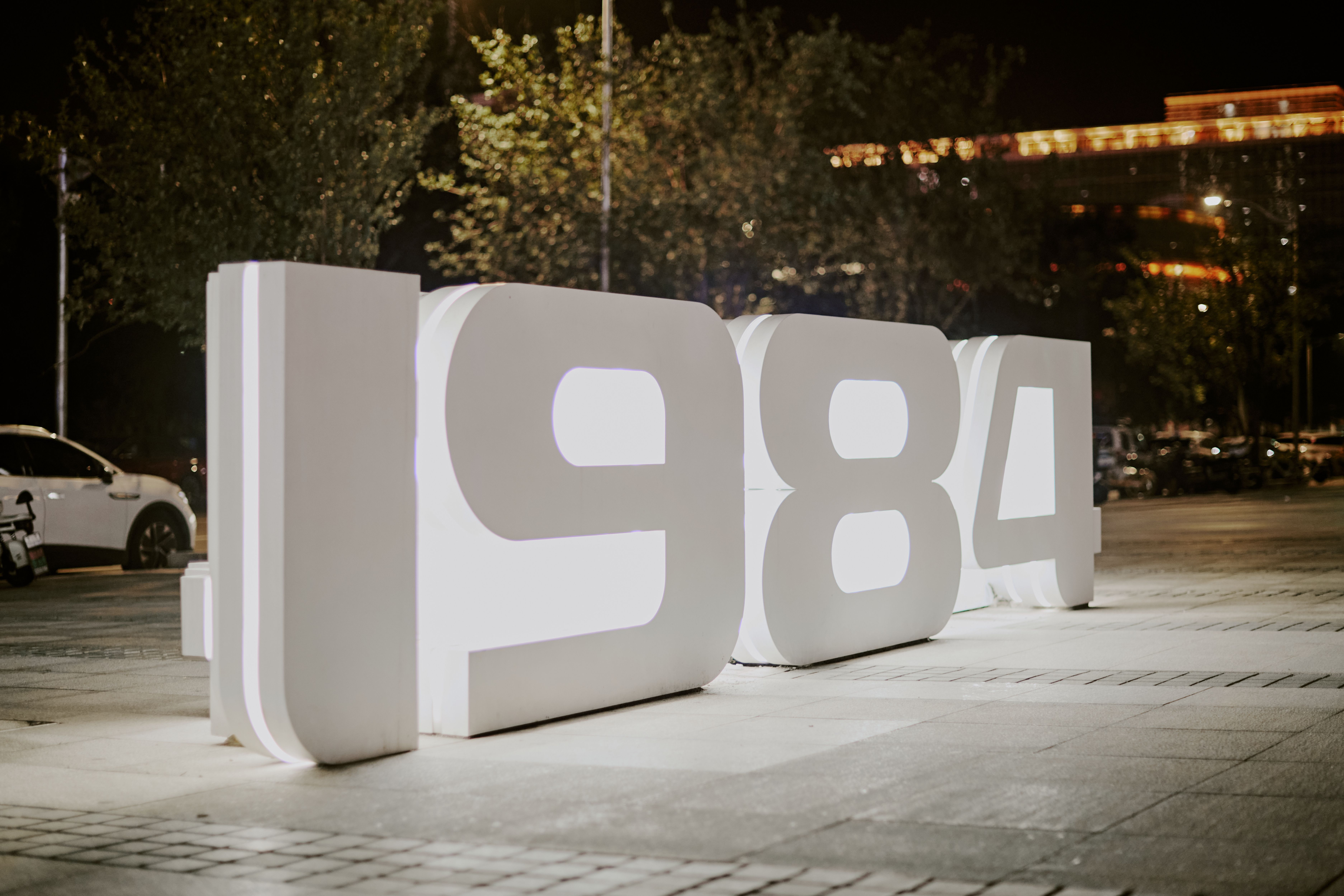 Illuminated 1984 Sign at Night in Urban Setting · Free Stock Photo