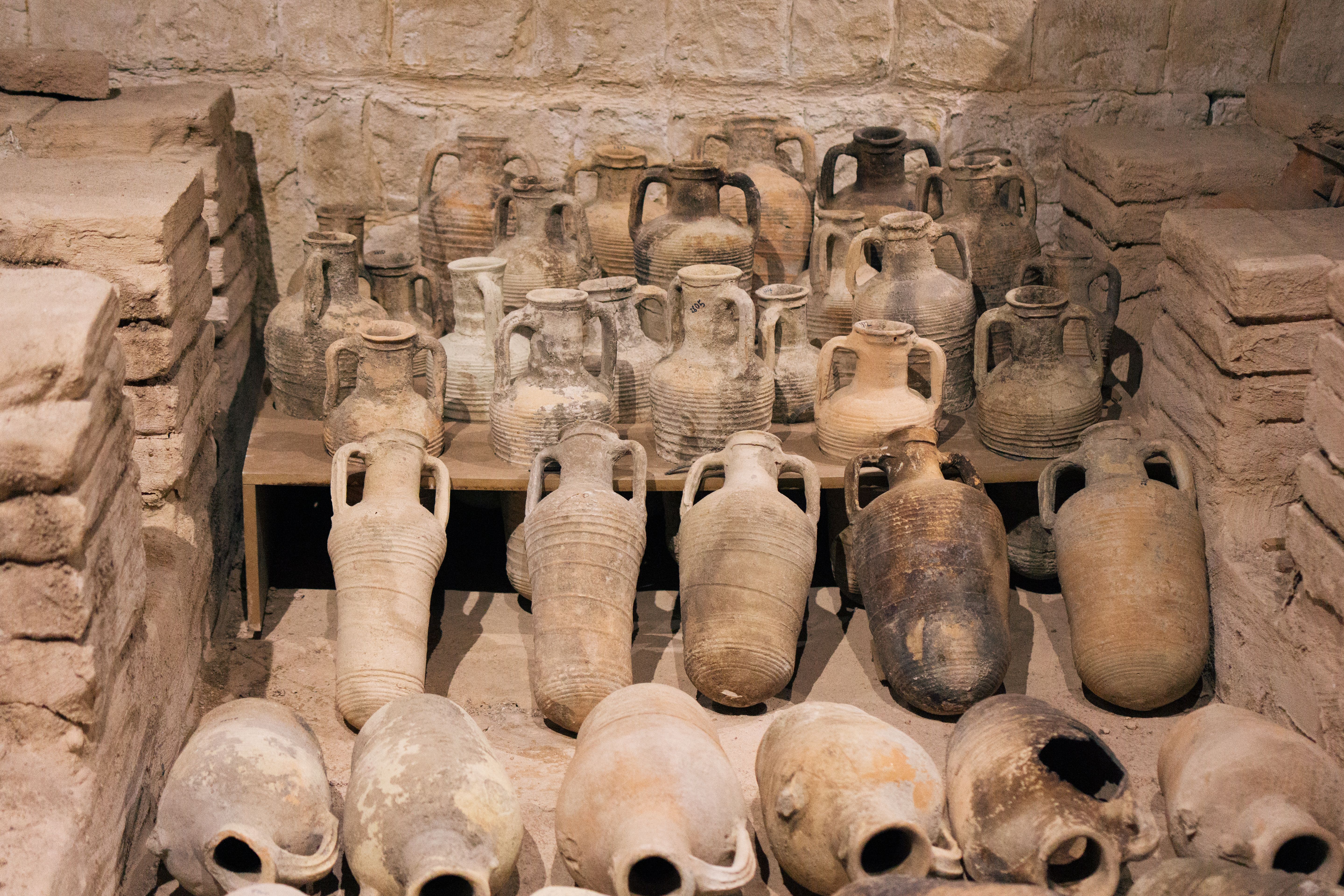 Ancient clay amphorae showcased at a museum in Mersin, Turkey, highlighting historical pottery techniques.