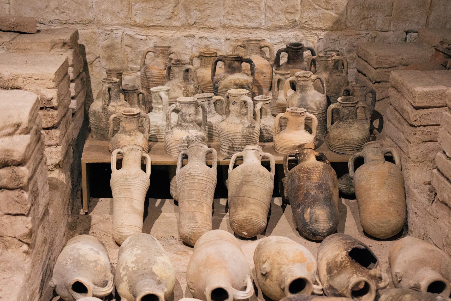 Ancient clay amphorae showcased at a museum in Mersin, Turkey, highlighting historical pottery techniques.