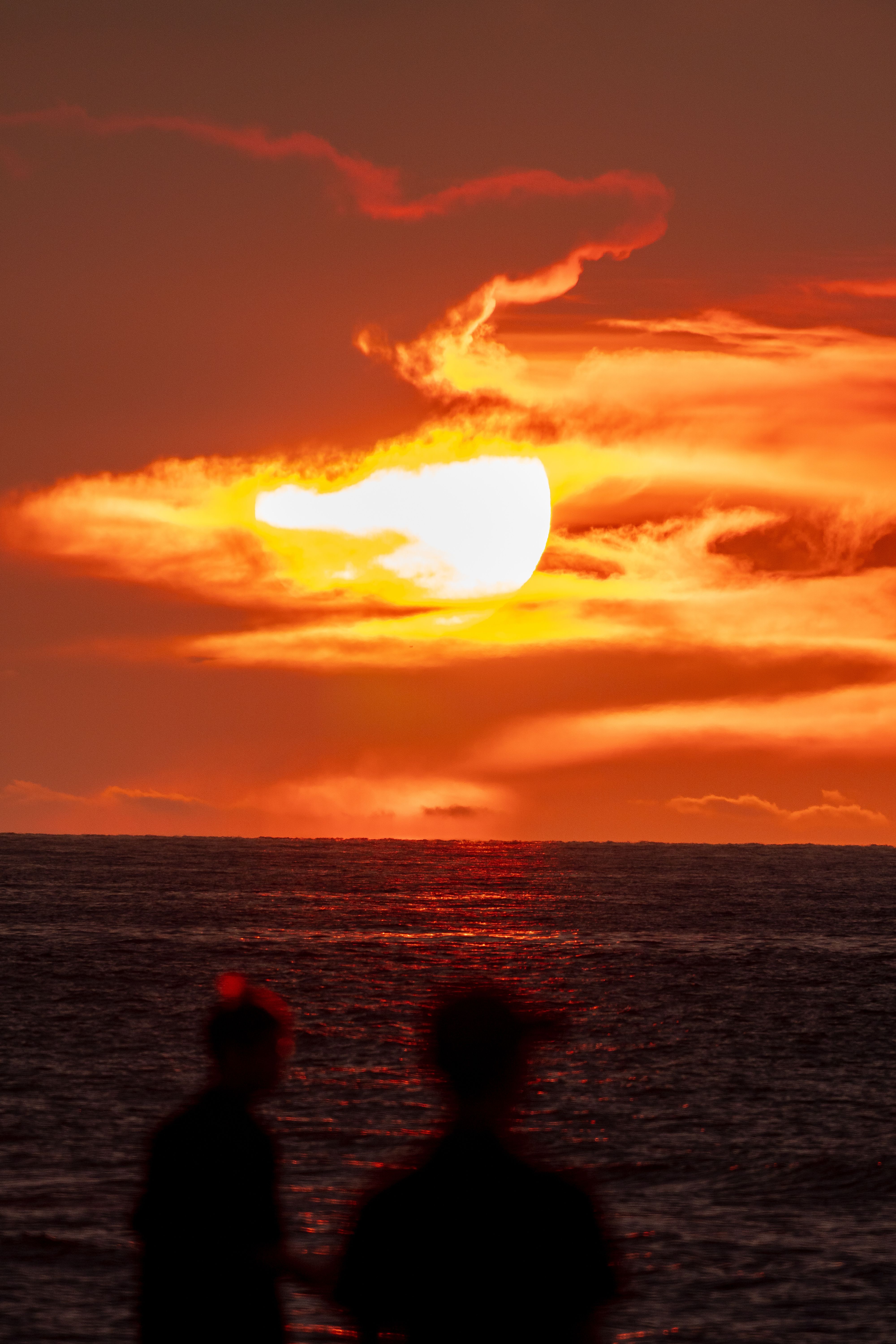 Stunning Sunset Over Ocean with Silhouettes · Free Stock Photo