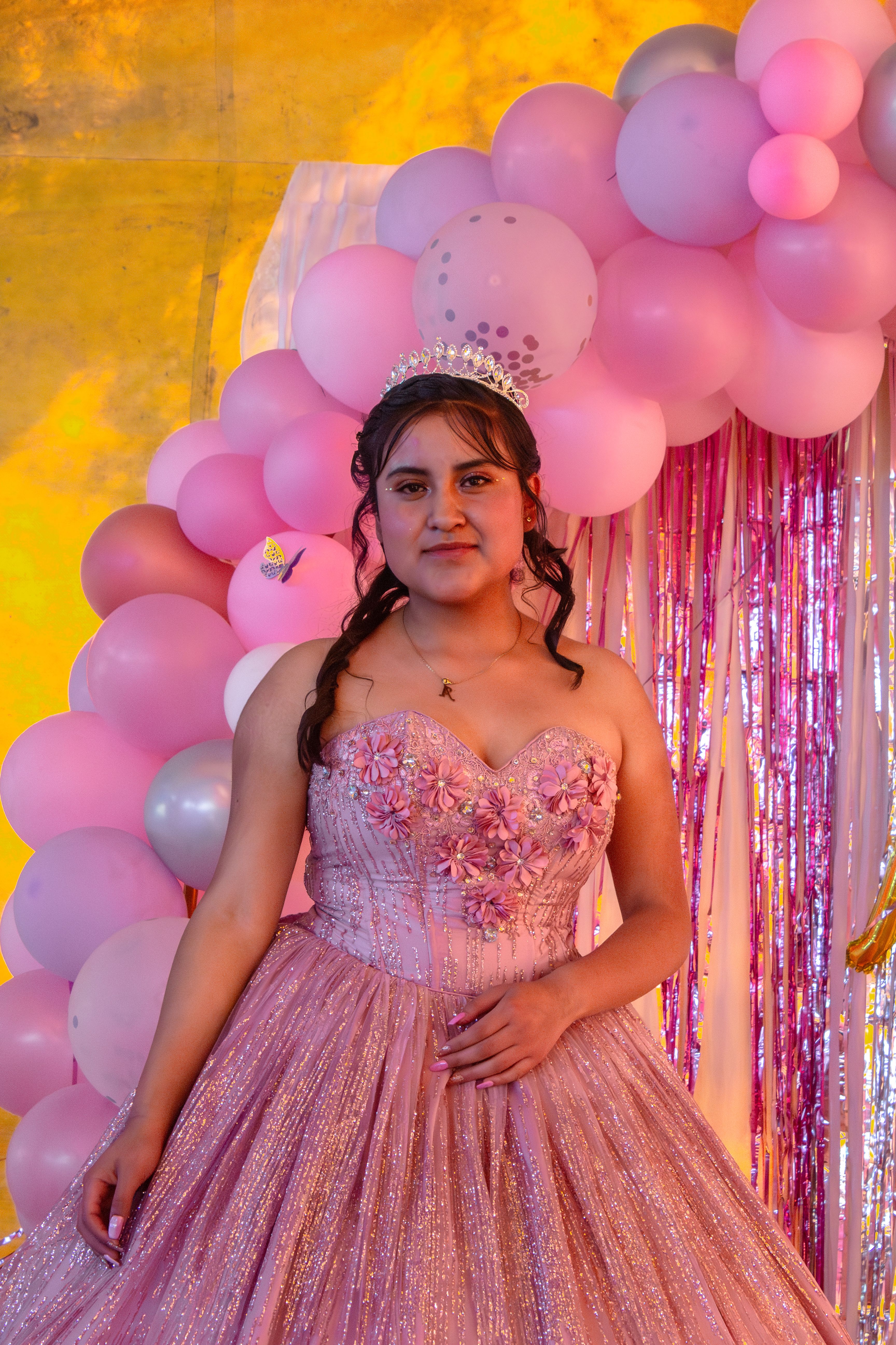 First birthday balloon decor ideas with pink balloon arch decoration at a birthday celebration