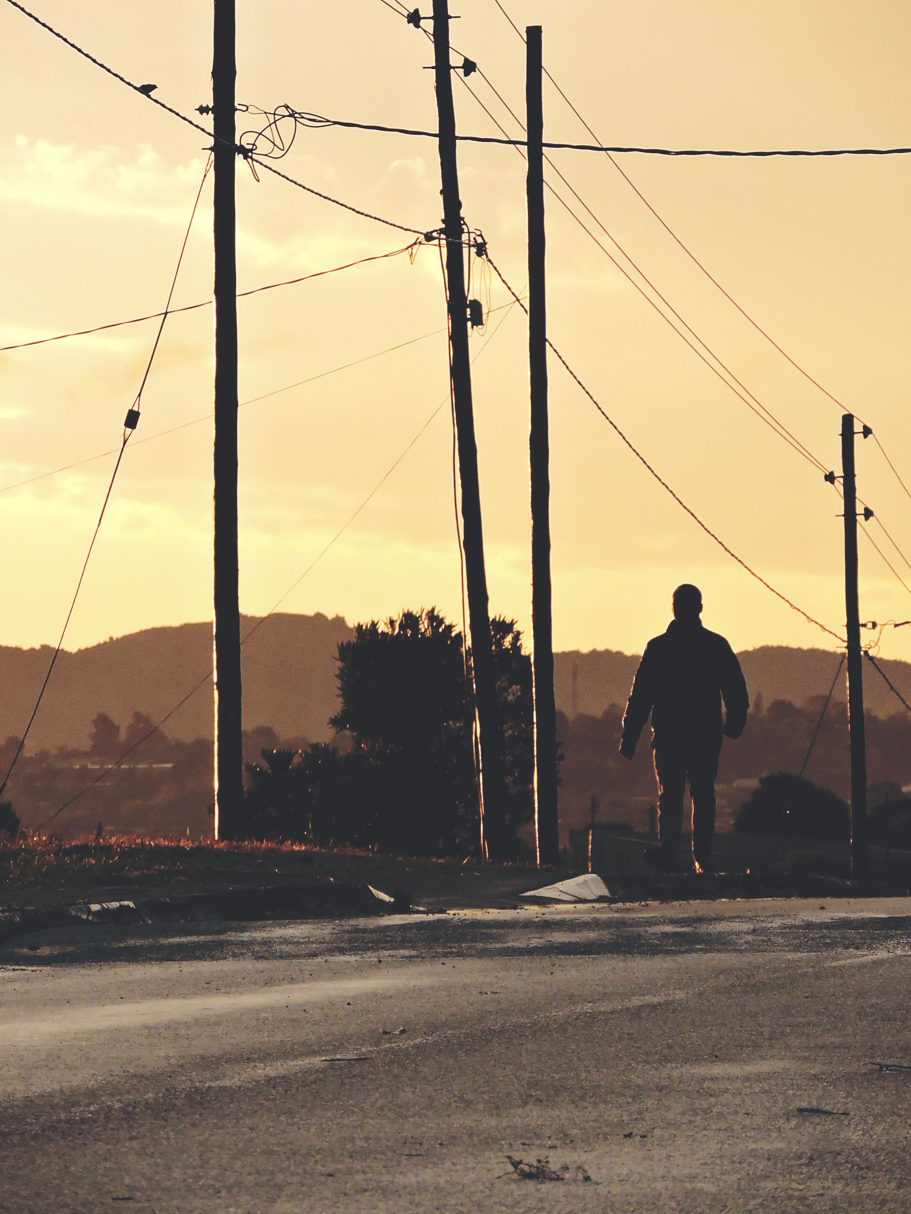 Silhouette of a Man Walking at Sunset · Free Stock Photo
