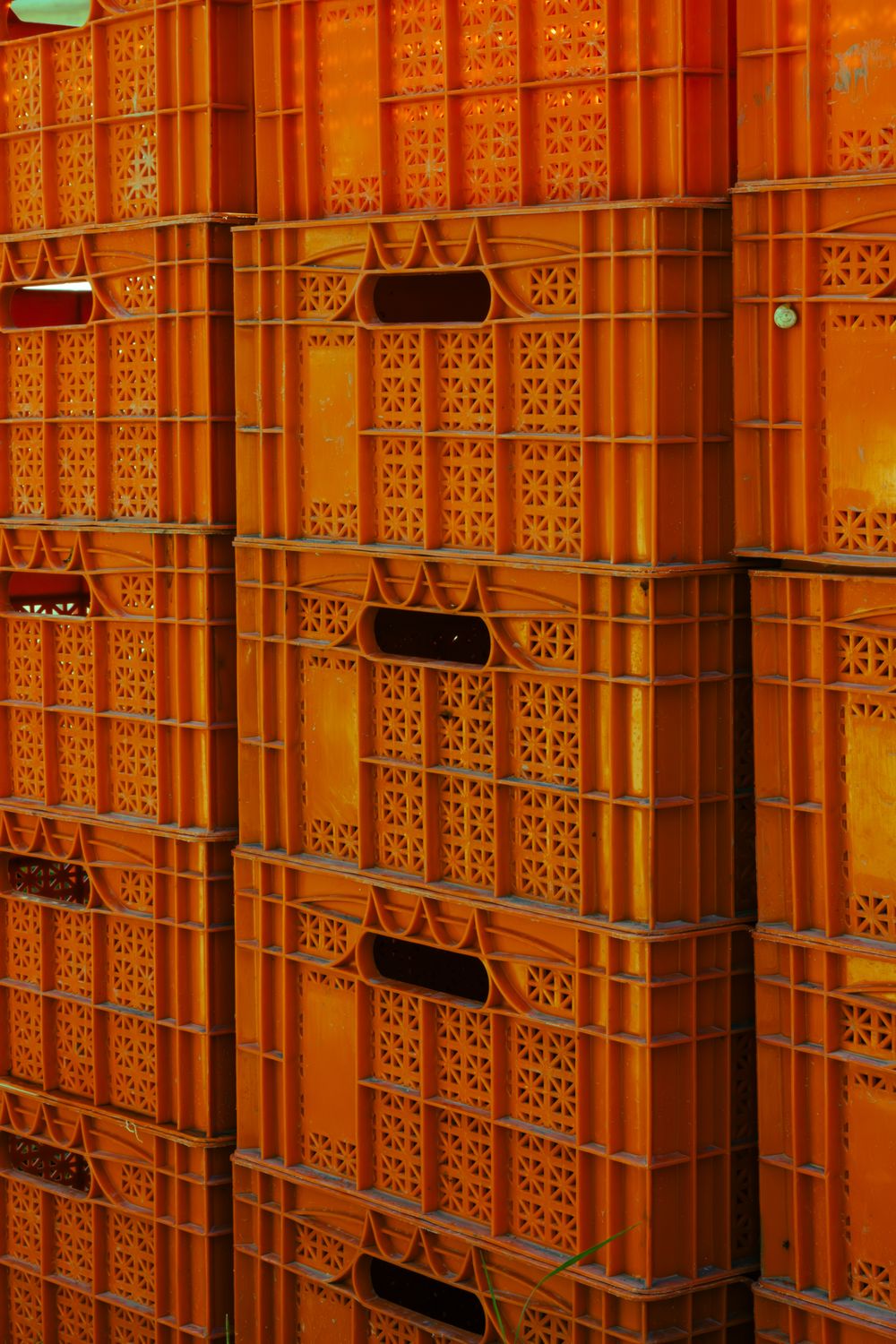 Stacked Orange Plastic Crates in Warehouse · Free Stock Photo