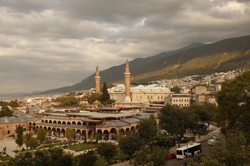 Free A beautiful aerial view of Bursa, Turkey featuring the historic Ulu Cami Mosque under a dramatic sky. Stock Photo