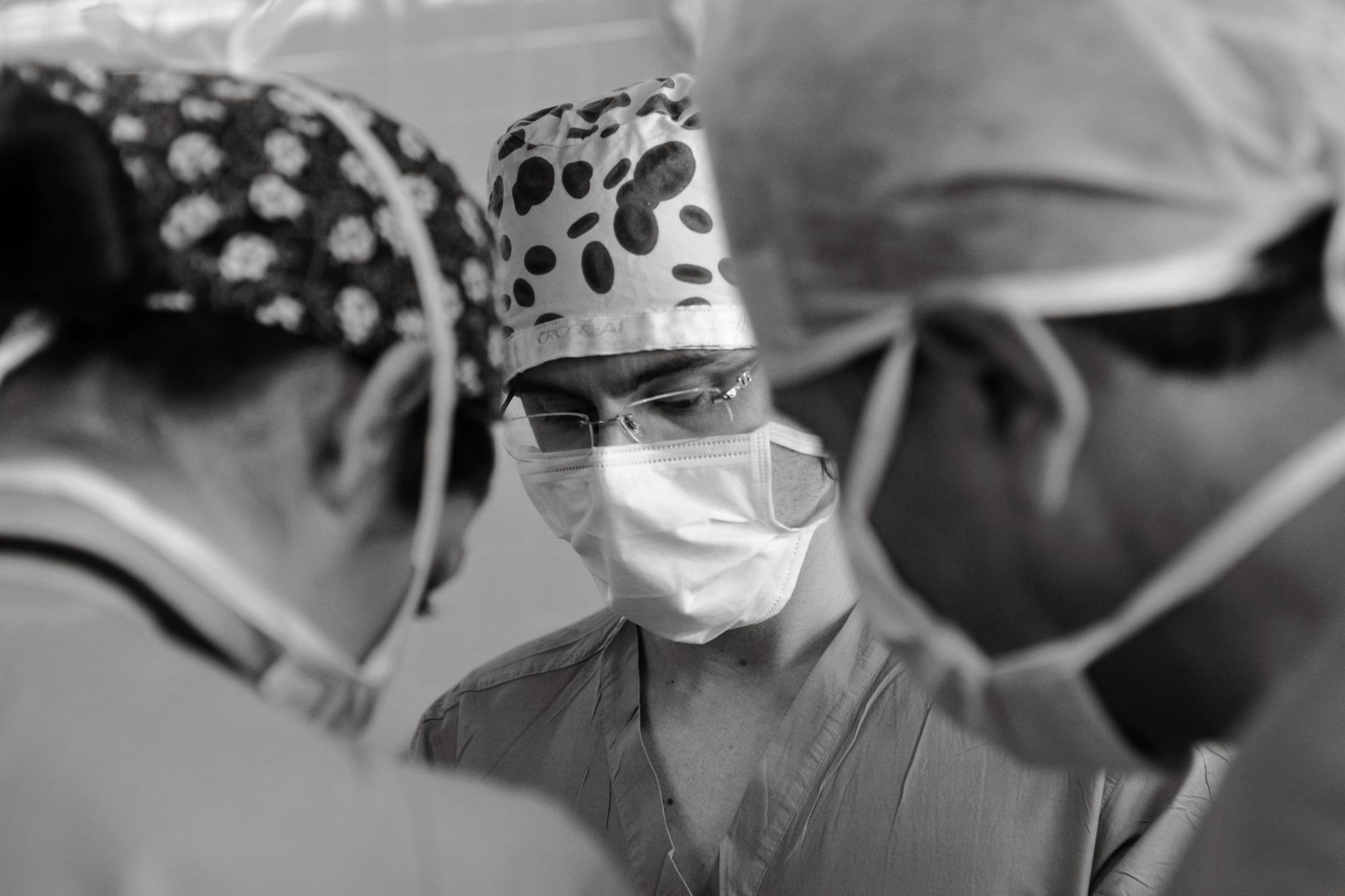 Focused medical team performing surgery in a hospital operating room.