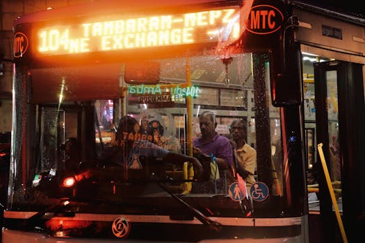 Public transport bus at night with LED route display and passengers inside.