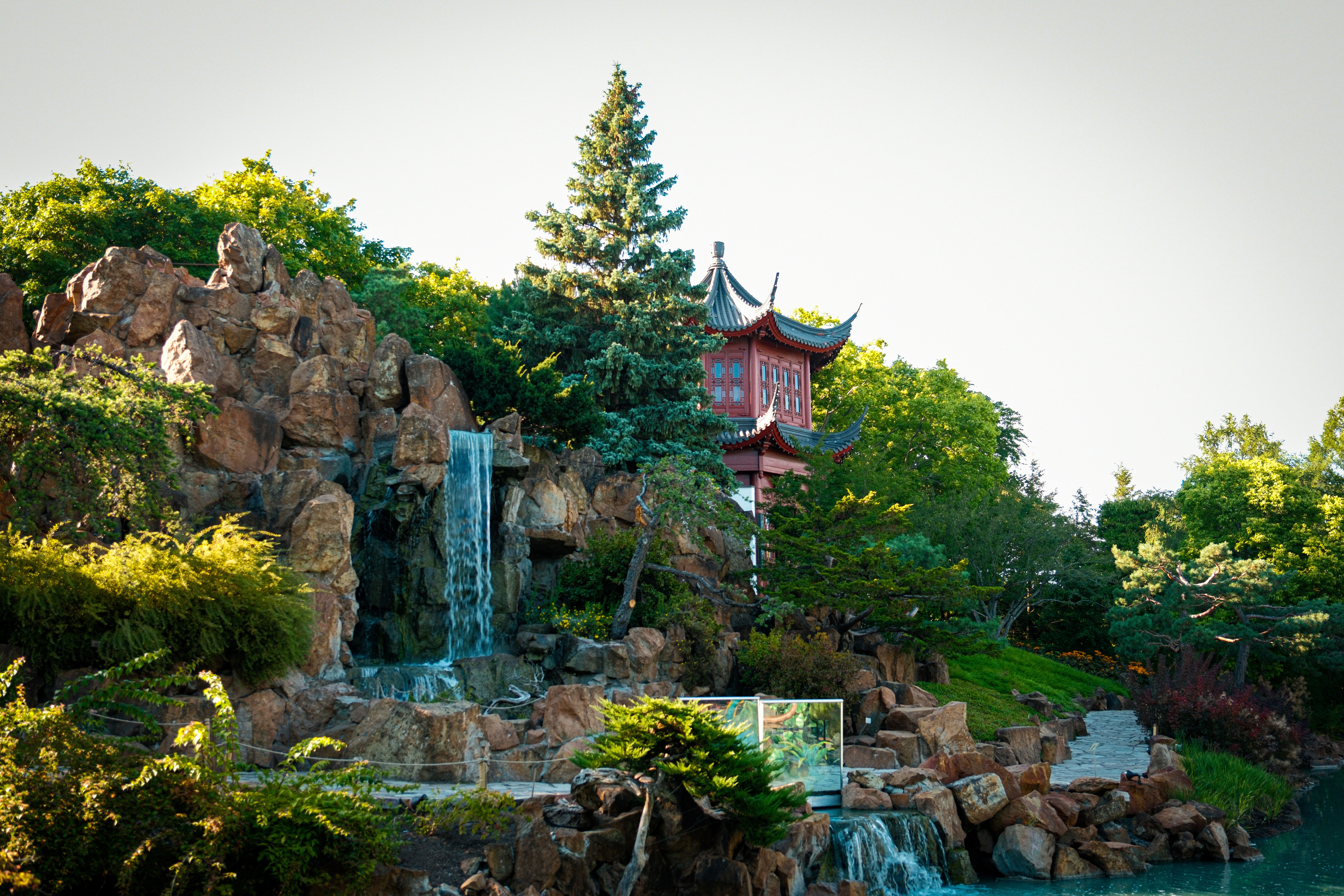 Beautiful Chinese garden in Montréal featuring a serene waterfall and rich foliage.