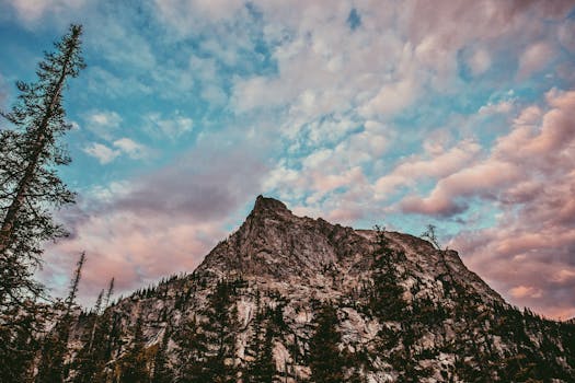 Explore a stunning mountain peak against a vibrant sky, showcasing Colorado's natural beauty.