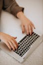 Woman's Hands Typing on Laptop Keyboard
