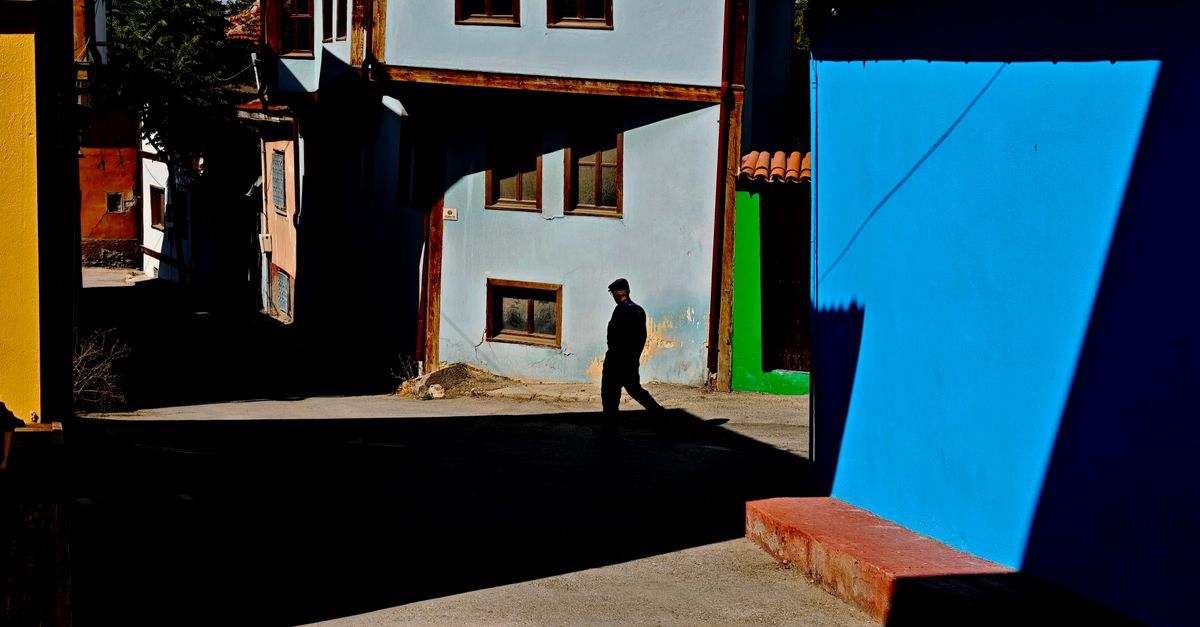 person walking outdoors morning sunlight neighborhood