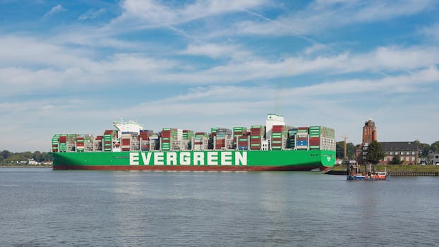 A large Evergreen container ship docked at Hamburg port, showcasing global commerce on a sunny day.