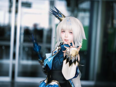 Stunning portrait of a person in elaborate fantasy cosplay indoors.