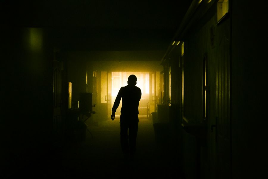 Silhouetted figure in a dim corridor — photo by Osman İçli on Pexels