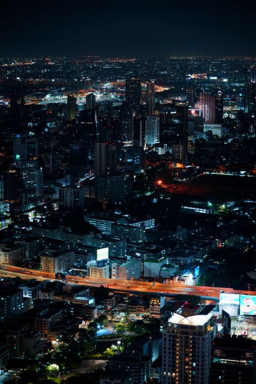 Free Aerial view of Bangkok's dynamic skyline illuminated at night Stock Photo