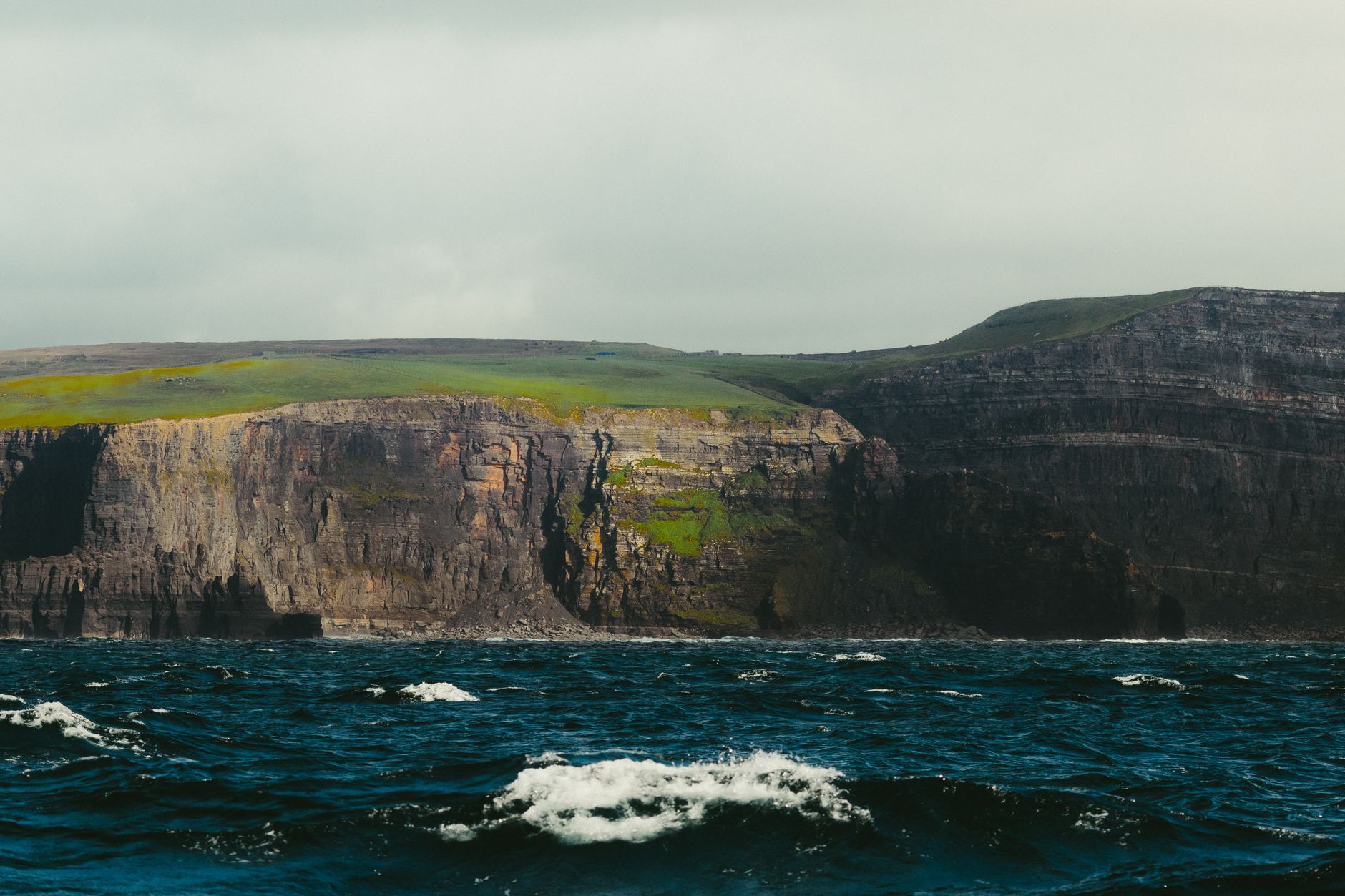 Majestic cliffs of Inishmore, County Galway, rising above turbulent waters.