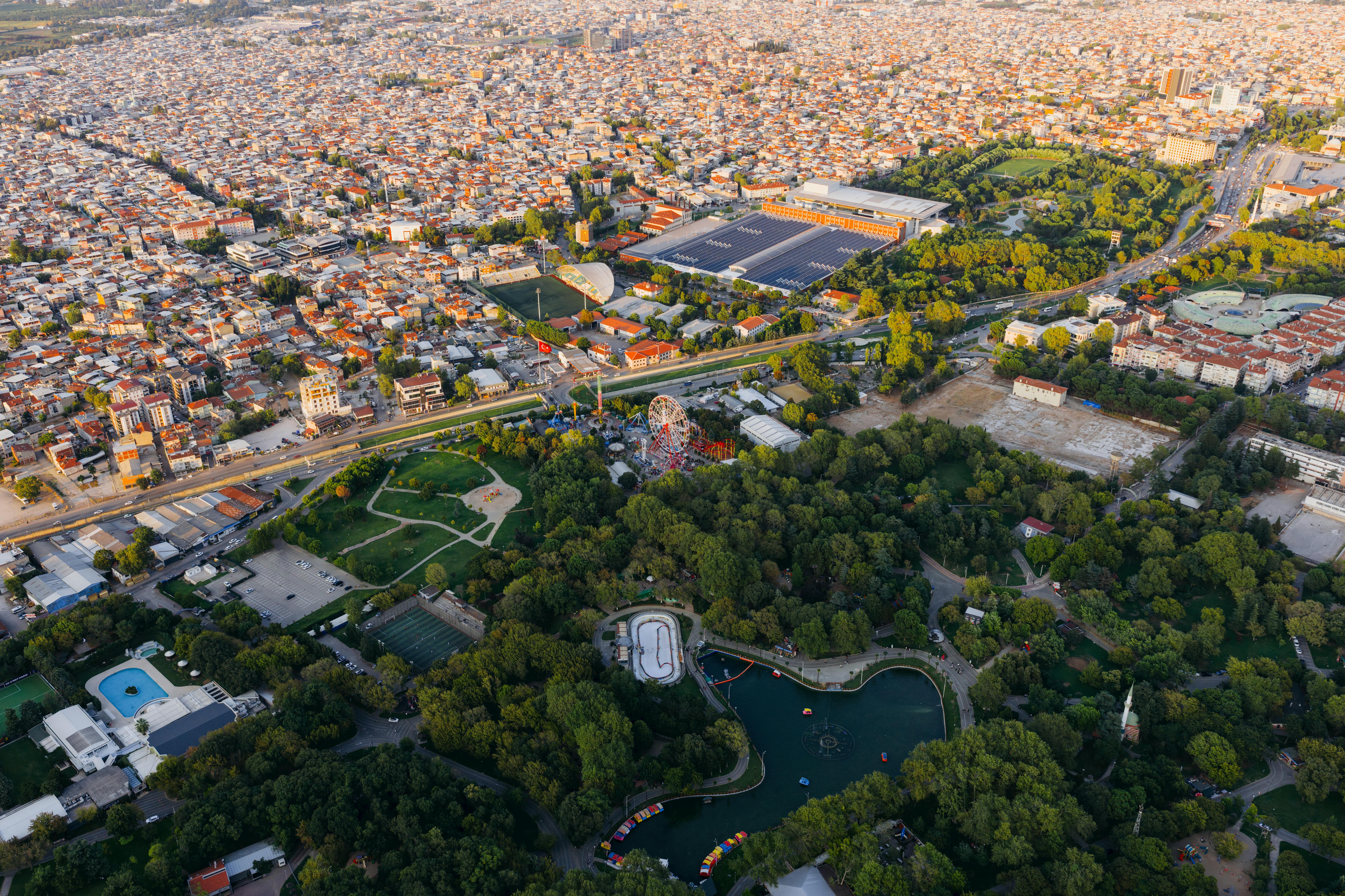 Aerial shot over Reşat Oyal Culture Park in Bursa, featuring urban and natural landscapes.