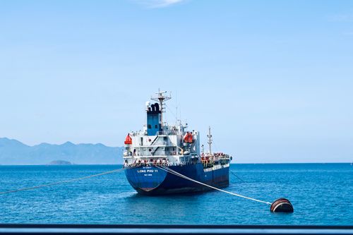 Free A large cargo ship moored in the clear waters of Nha Trang Bay, Vietnam. Stock Photo