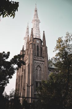 Stunning view of a Gothic cathedral with dramatic spires in Jakarta, captured in soft light.