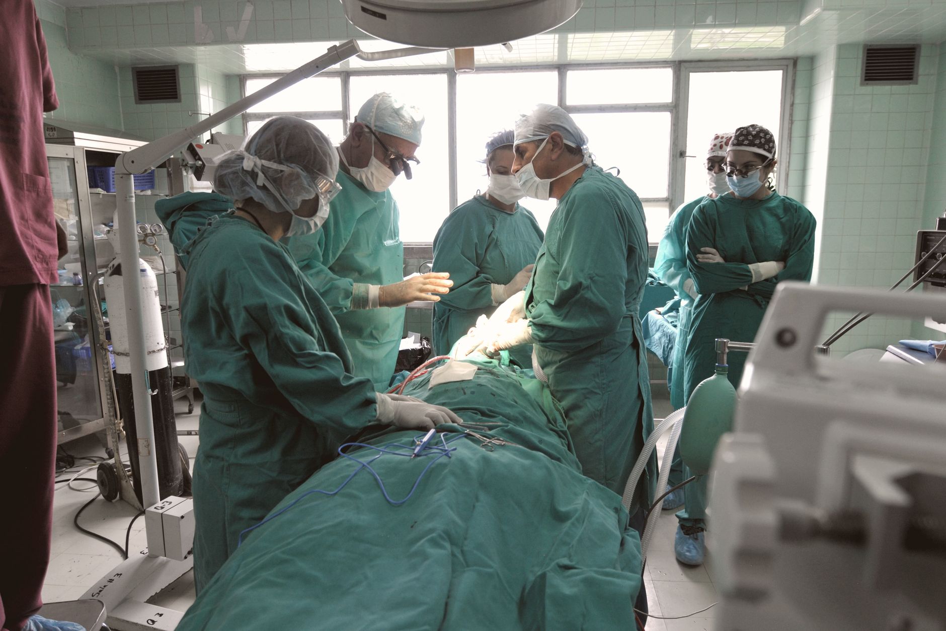 A team of surgeons in an operating room focused on a critical procedure.