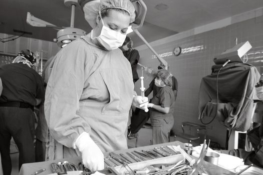 Surgical team in an operating room focused on a procedure, showcasing precision and teamwork.