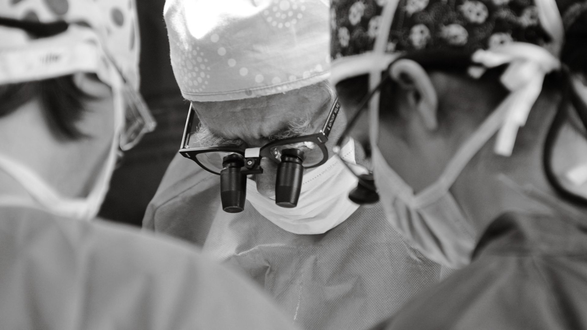 Modafinil for Surgeons: A Game-Changer in the Operating Room A team of surgeons focused on a procedure in a hospital operating room, captured in black and white — modafinil for surgeons
