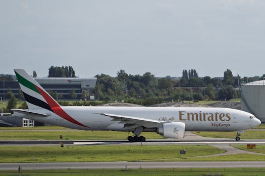 Emirates SkyCargo Boeing 777 aircraft taxiing on airport runway.