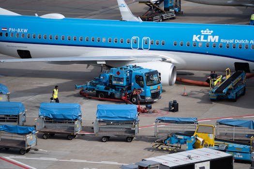 Close-up of KLM aircraft during ground handling operations at an airport.