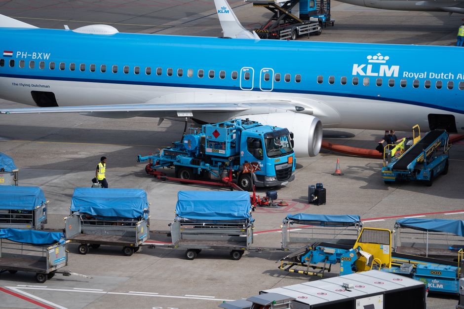 Close-up of KLM aircraft during ground handling operations at an airport.