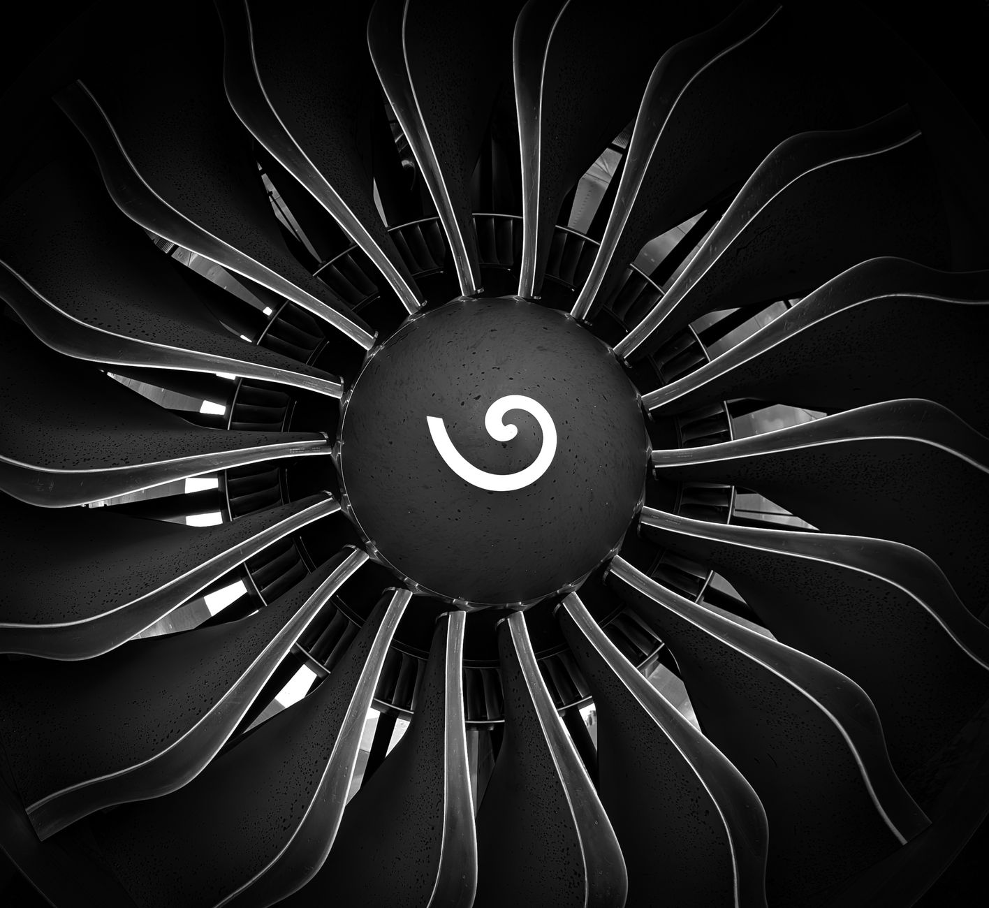 generative engine optimization tools, Black and white abstract of an airplane turbine engine fan showcasing symmetrical blades.