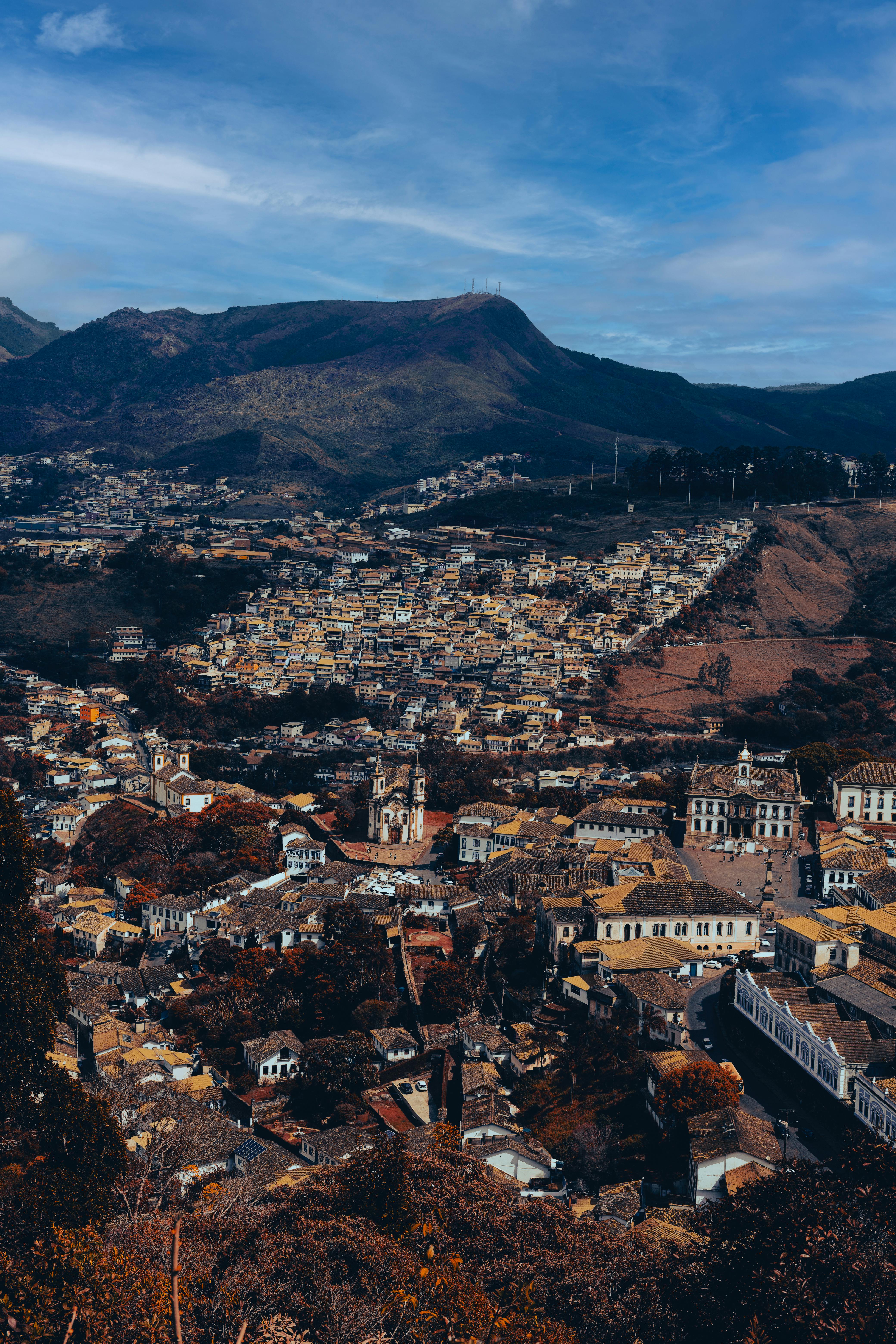 Panoramic view of Ouro Preto's historic architecture against mountain backdrop.