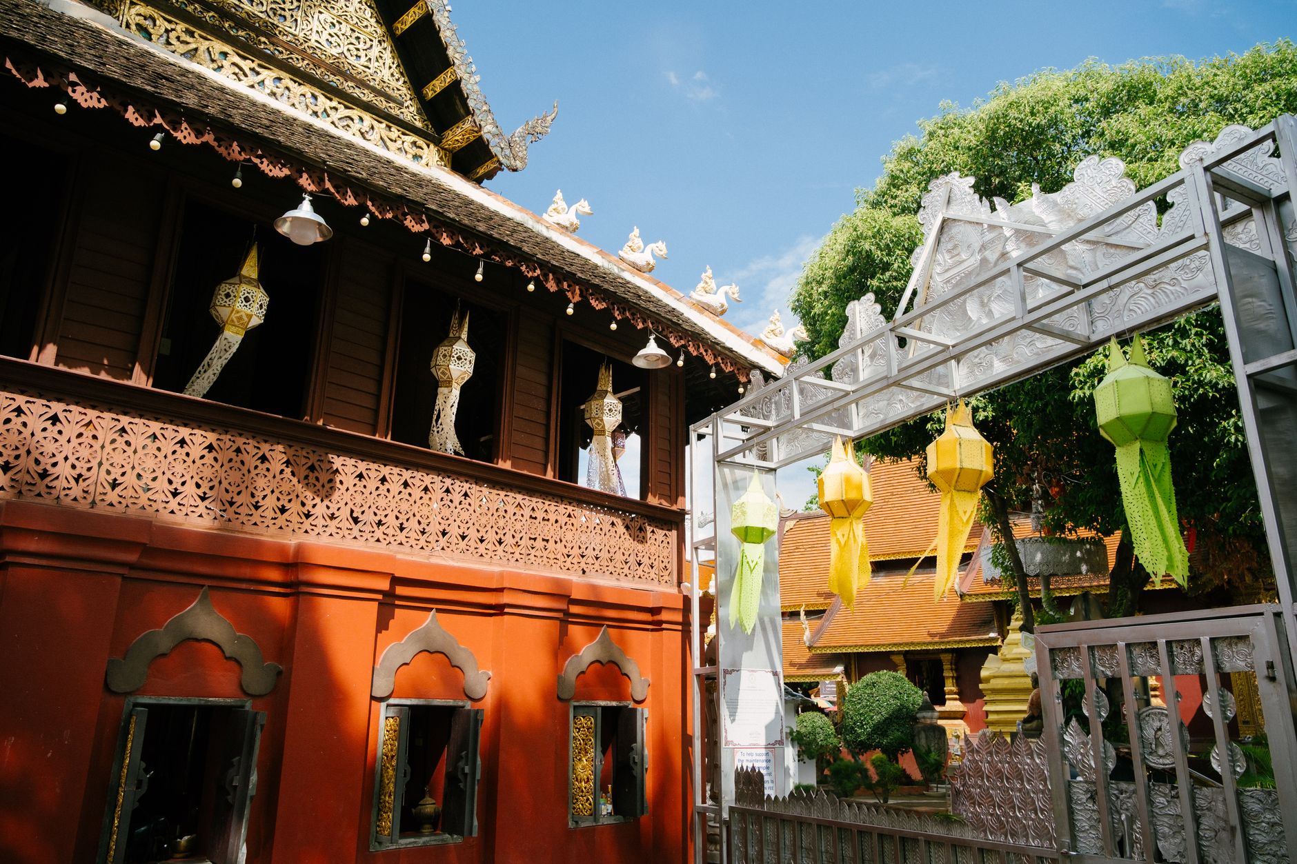 Stunning view of colorful lanterns and ornate temple architecture in Chiang Mai, Thailand.