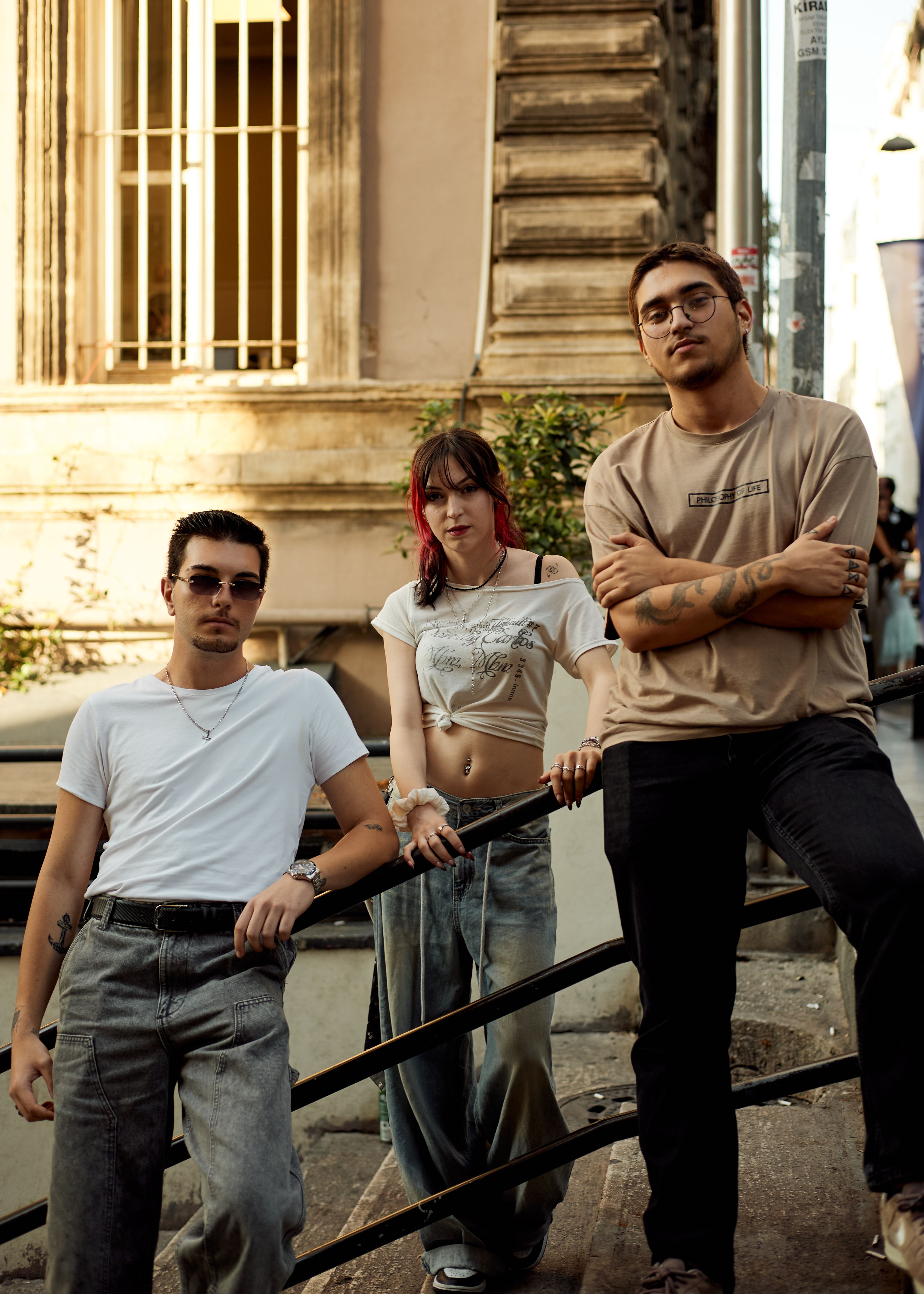 Group of stylish young adults hanging out outdoors in Istanbul, displaying urban fashion.