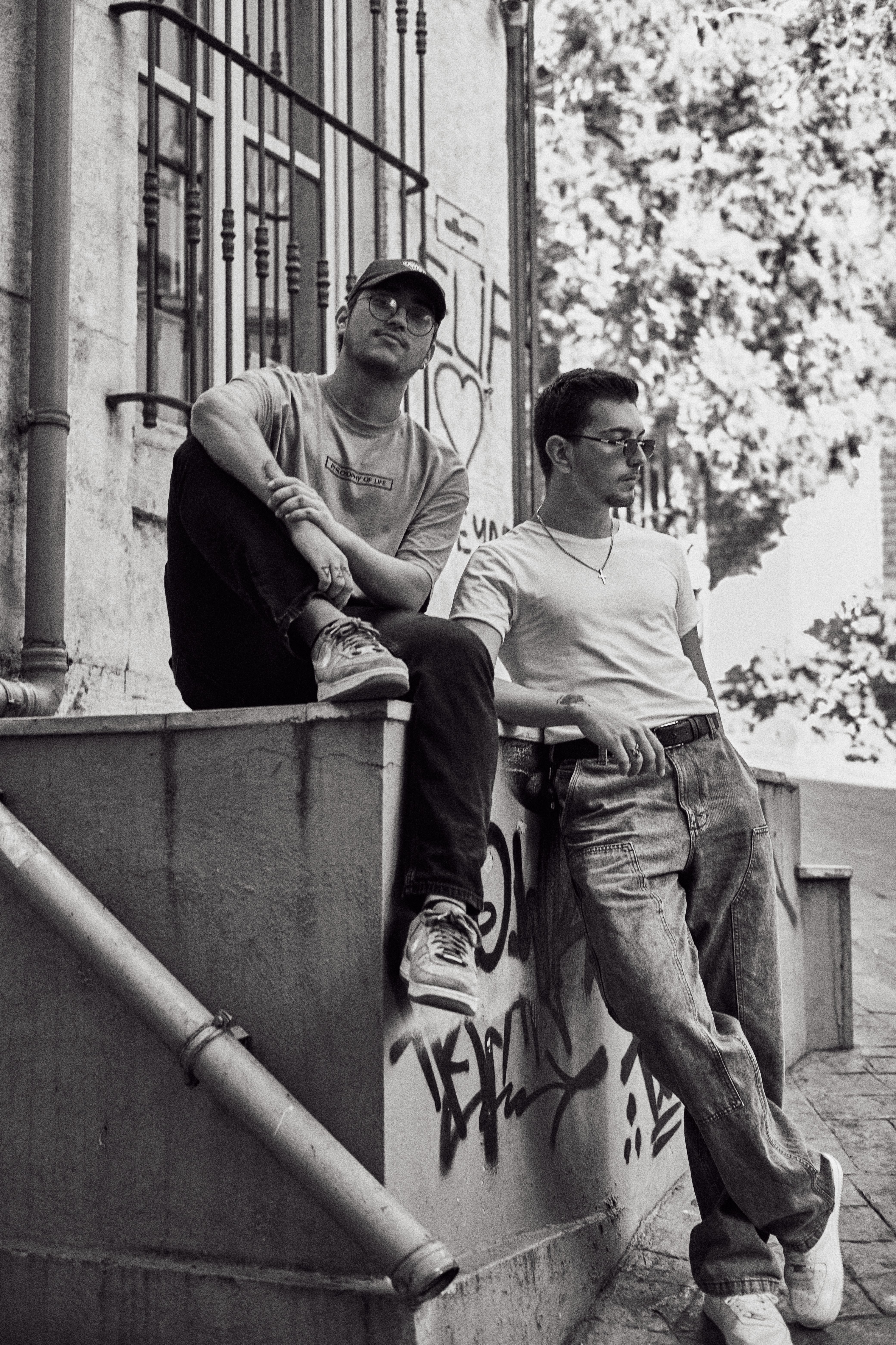 Casual black and white portrait of two men in Istanbul's urban setting.