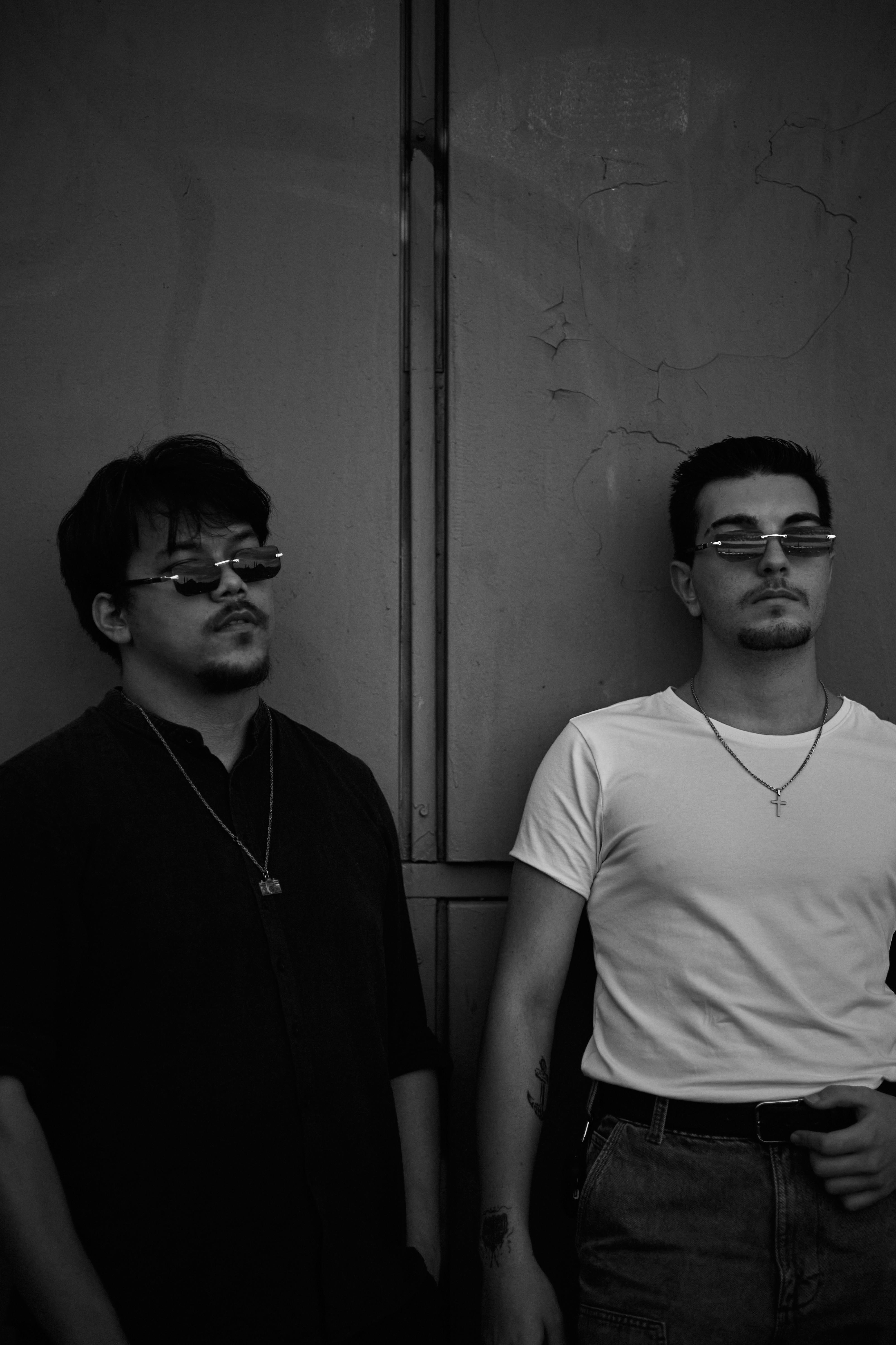 Free Two stylish young men wearing sunglasses stand against an urban background in Istanbul, Turkey. Stock Photo