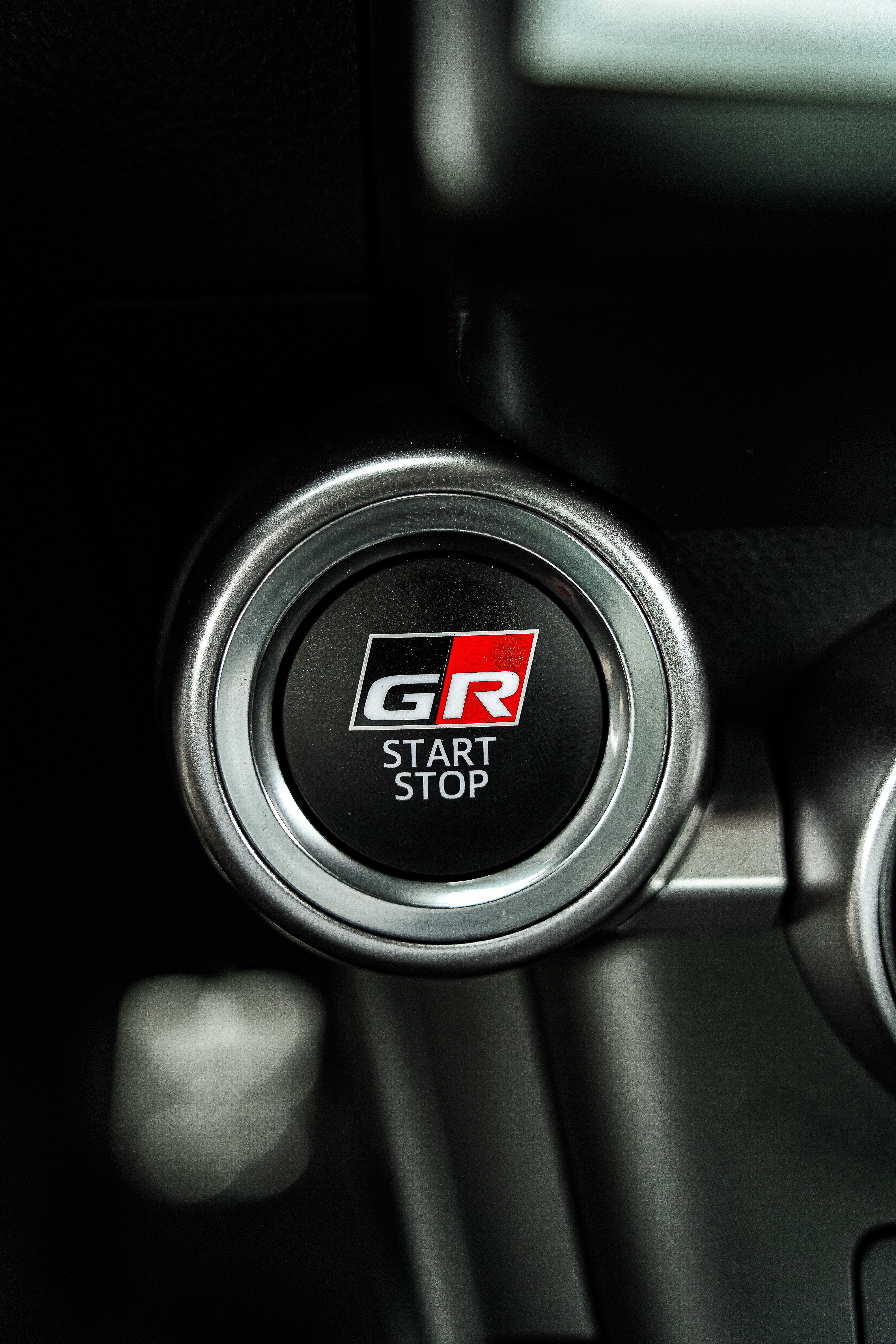 Detailed view of GR start stop button in modern car interior. Ideal for automotive themes.