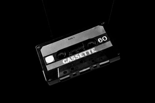 Classic cassette tape on a black background, capturing retro audio nostalgia.
