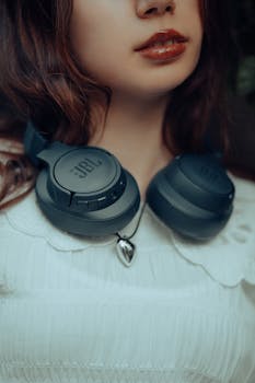 Close-up of a young woman's face and neck wearing headphones, showcasing a modern lifestyle.