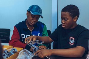 Two students assembling a robot together