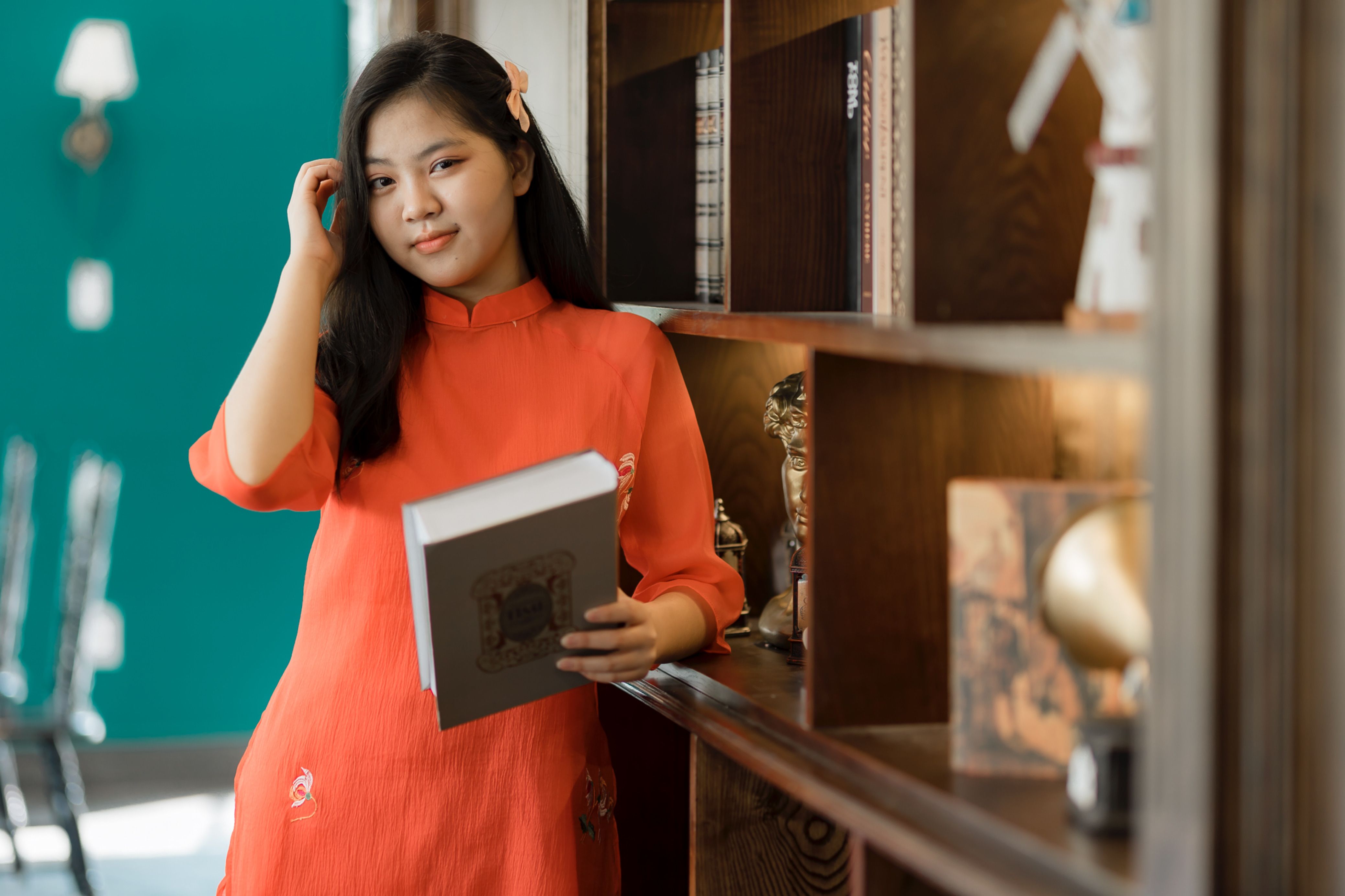Young Woman in Traditional Dress Holding Book