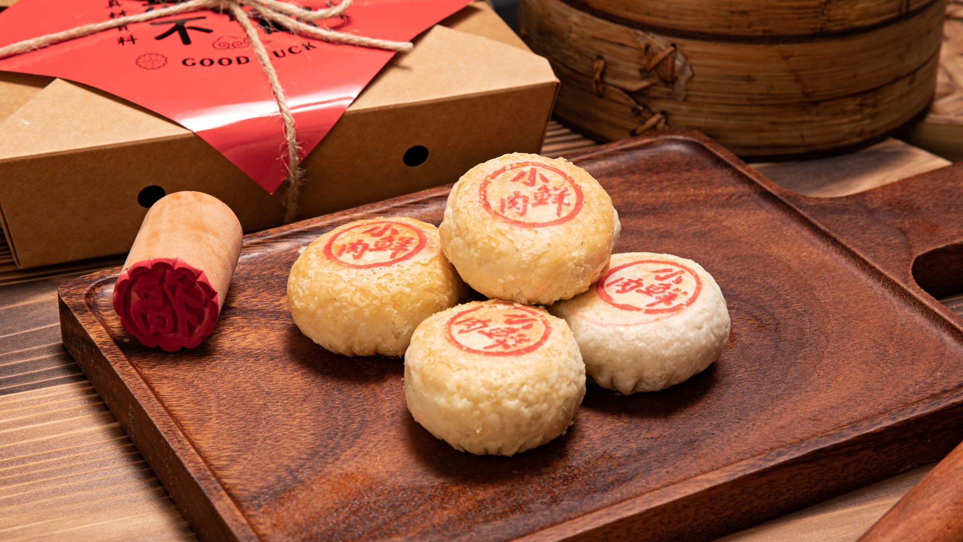 Close-up of traditional Chinese mooncakes with red stamps on a wooden board, ideal for festive occasions.
