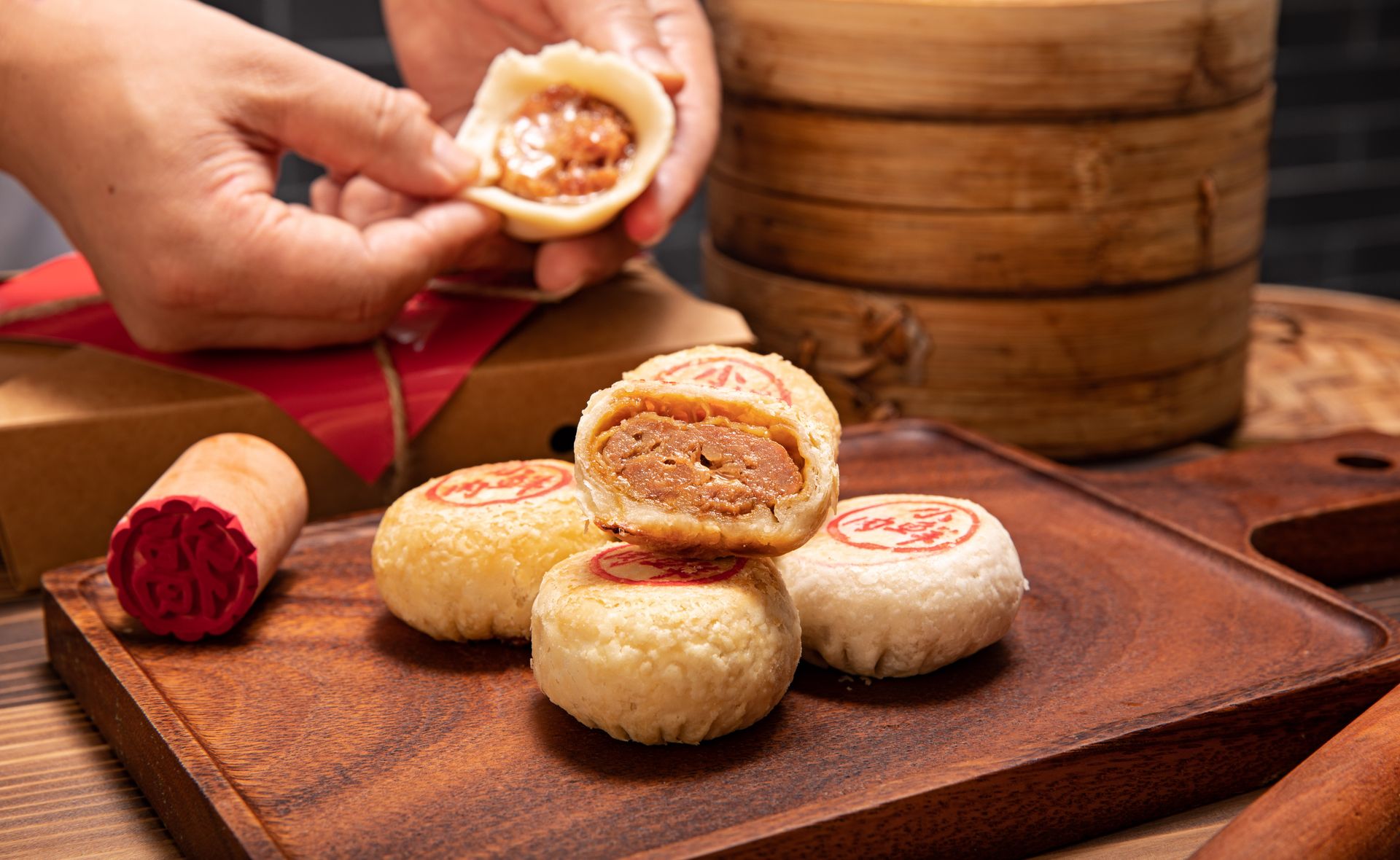 Close-up of traditional Chinese mooncakes on a wooden tray, perfect for festive celebrations.