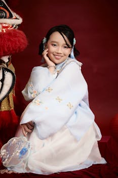 A cheerful child in Vietnamese attire, with a dragon dance figure.