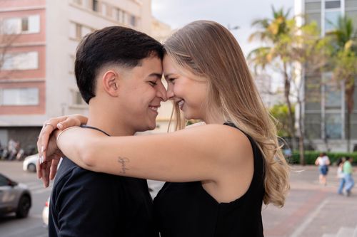 Free Smiling young couple embracing outdoors, capturing a tender moment in an urban setting. Stock Photo