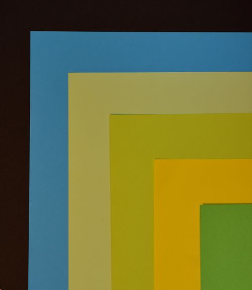 Free Bright, overlapping colored paper squares on black background create a bold visual. Stock Photo