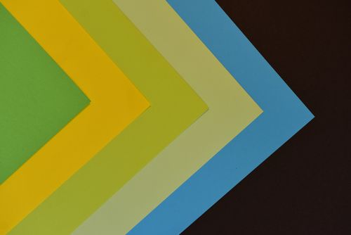 Free Geometric arrangement of colorful papers creating a vibrant abstract design. Stock Photo