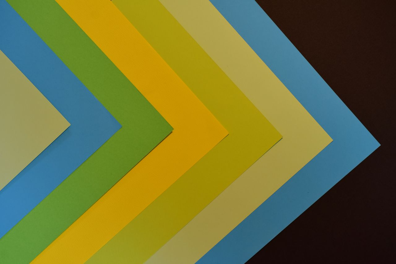 vibrant geometric design with layered colored paper creating an abstra