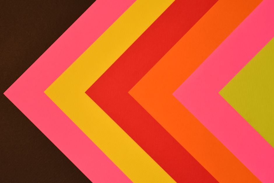 Vibrant chevron pattern with pink, yellow, orange, and red tones.