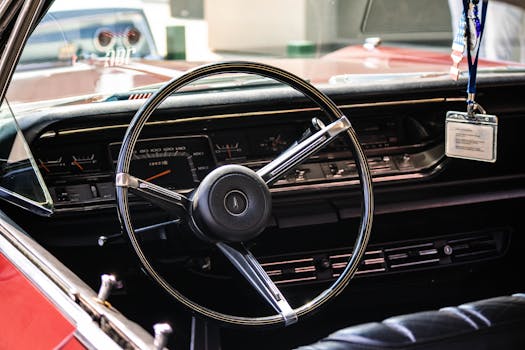 Interior view of a vintage American car, showcasing a classic steering wheel, taken in Istanbul, Turkey.